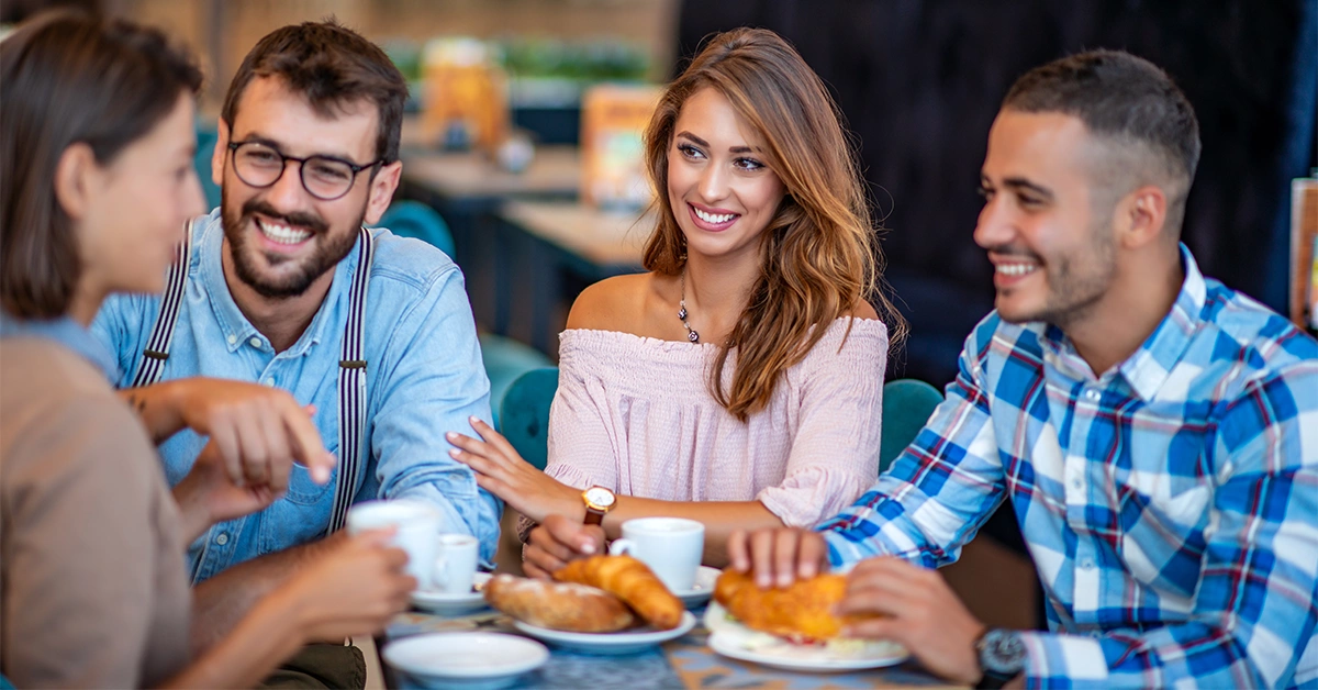 Four young friends enjoying food at a mall