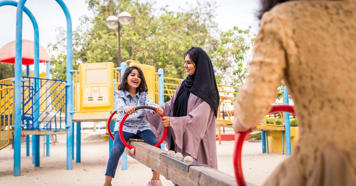 Children playing in a playing area at Dibba Al Hisn Public Park