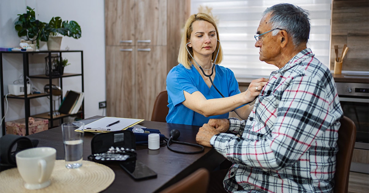 A nurse providing care to an elderly patient at one of the best clinics in Abu Shagara 