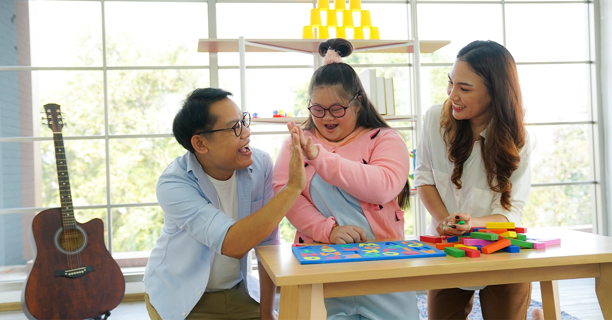 Instructors teaching a girl with Down syndrome at one of the special needs schools in Dubai