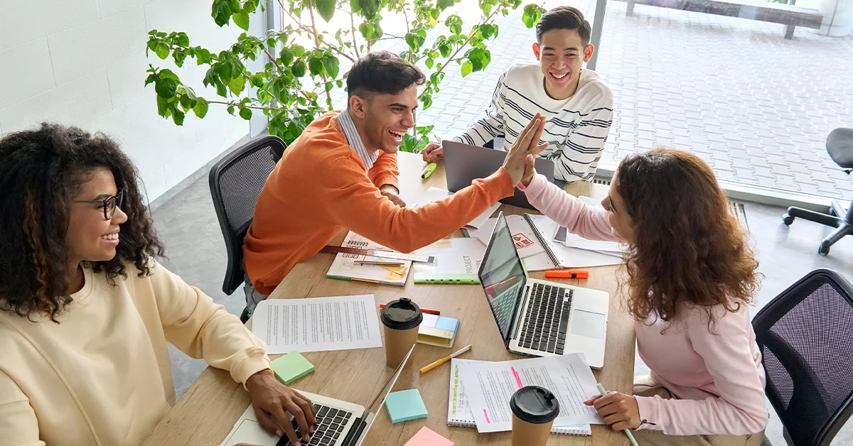 A team working together on a project at one of the best business schools in Dubai