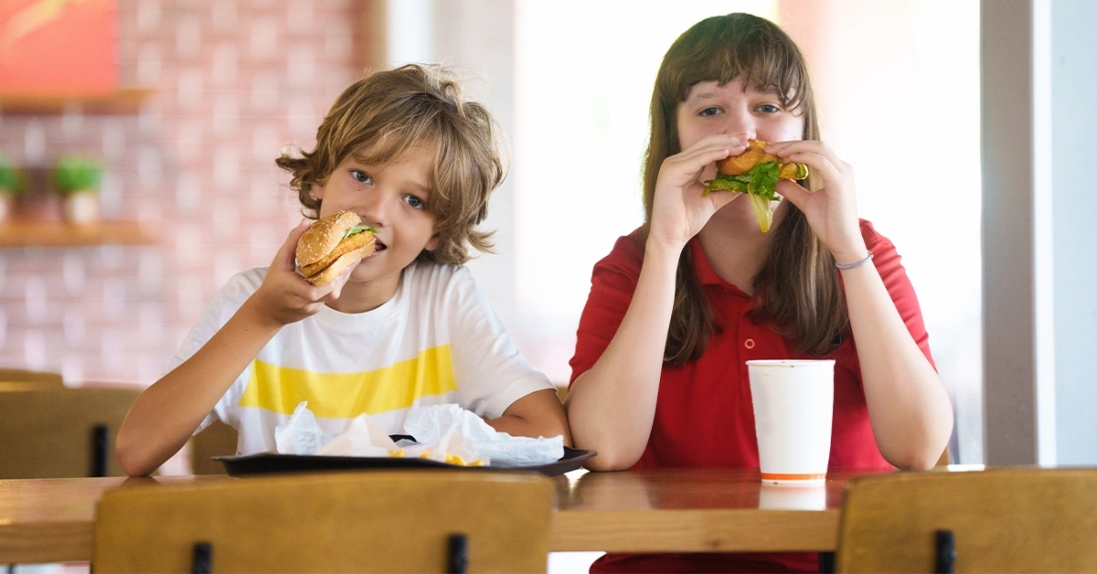 Kids enjoying burgers at a cafe in Dubai