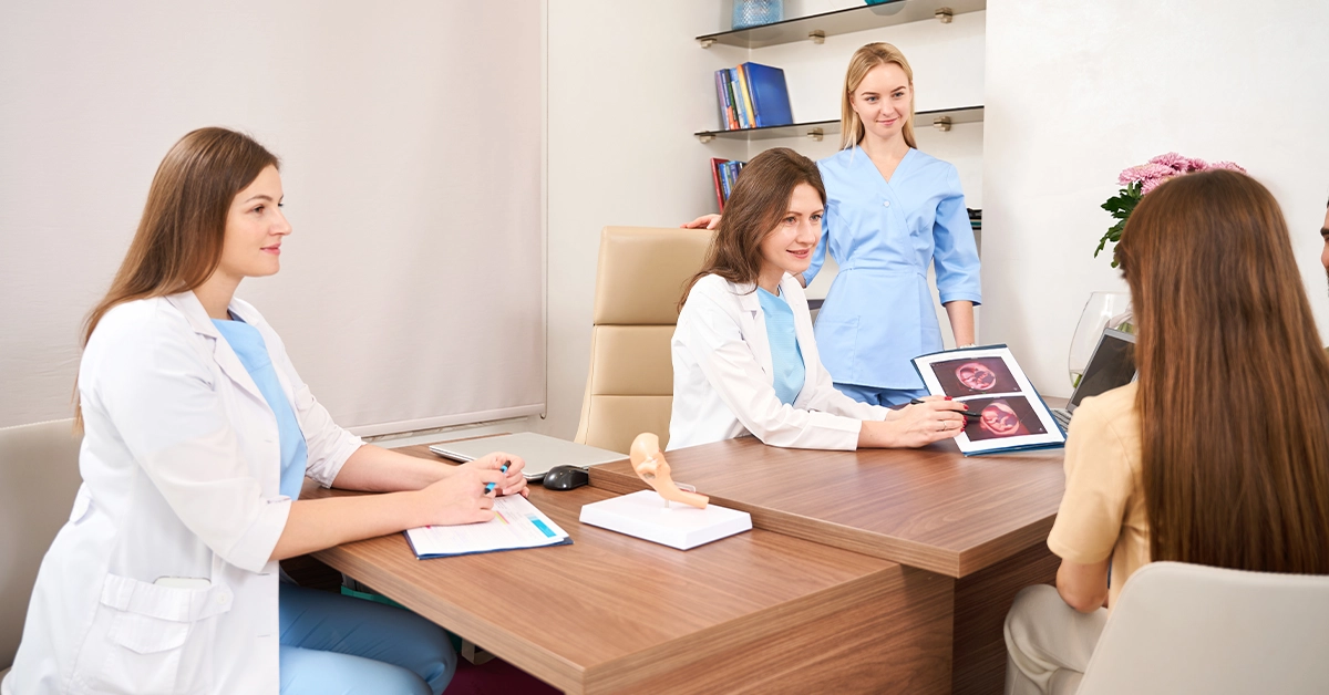 A gynaecologist showing the ultrasound scanning result to the mother