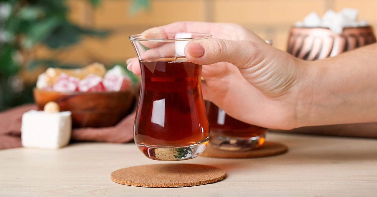 woman with a glass of Turkish tea