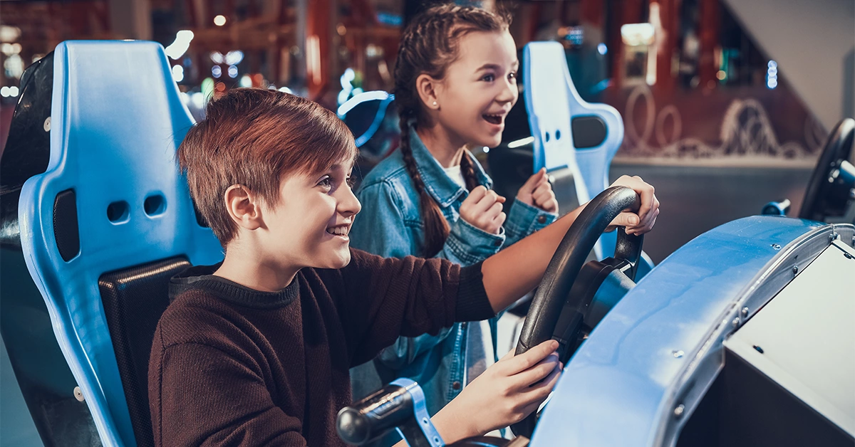 Siblings enjoying video games at Fun City