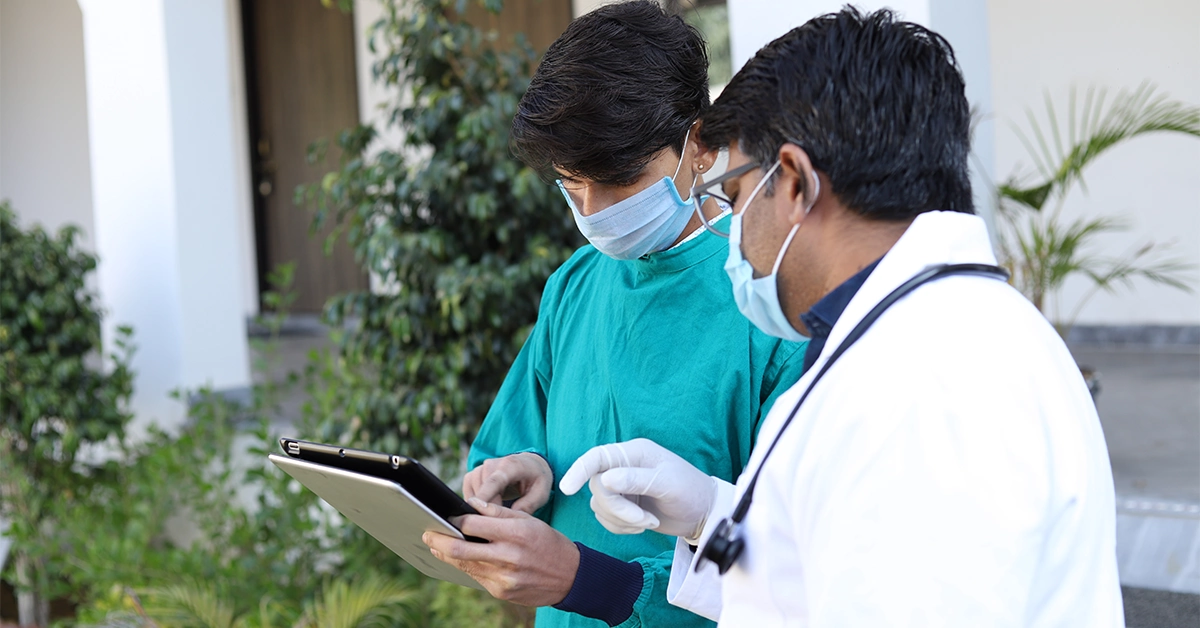 Two Doctors Discussing Patient’s Reports