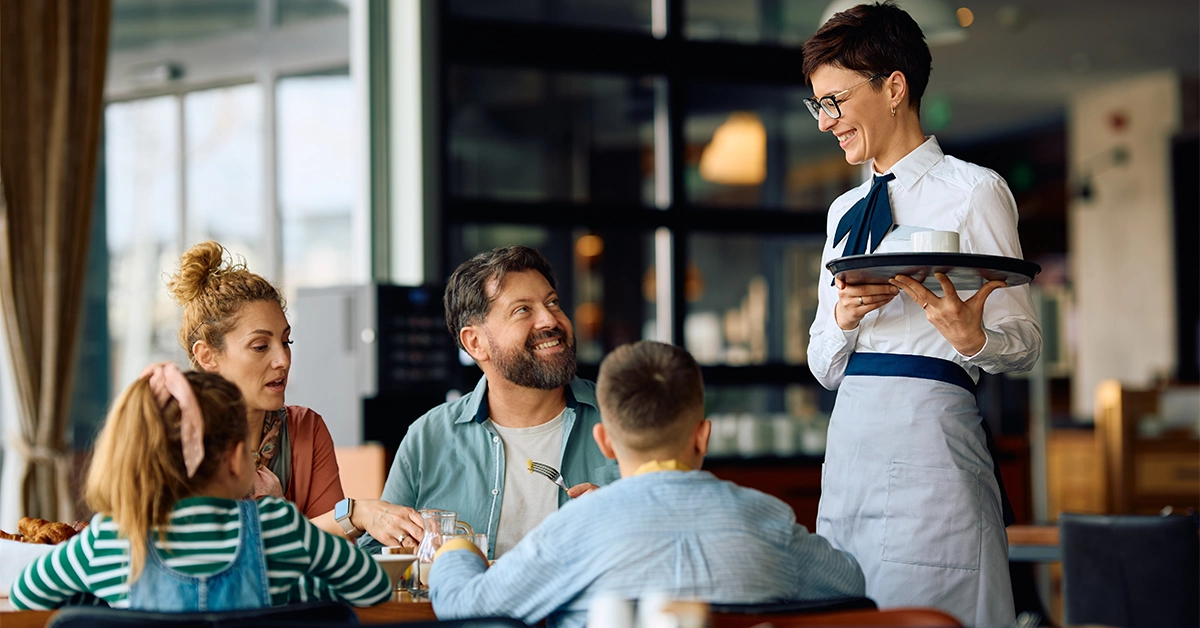 A waitress serving food to a family 