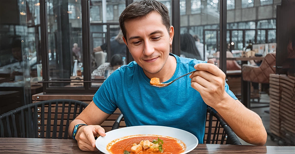 A man having delicious tomato soup
