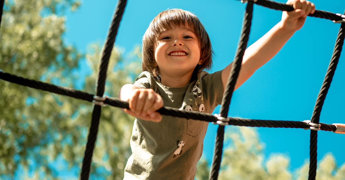 Boy Climbing a Rope Grid