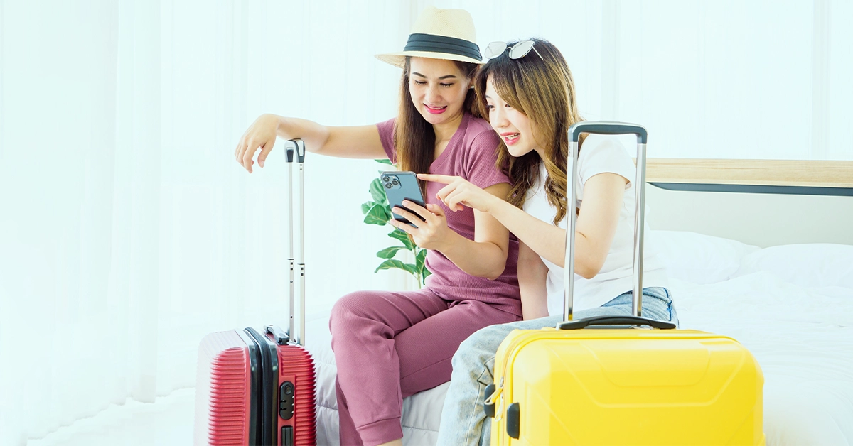 Two young Asian female friends ready for a trip