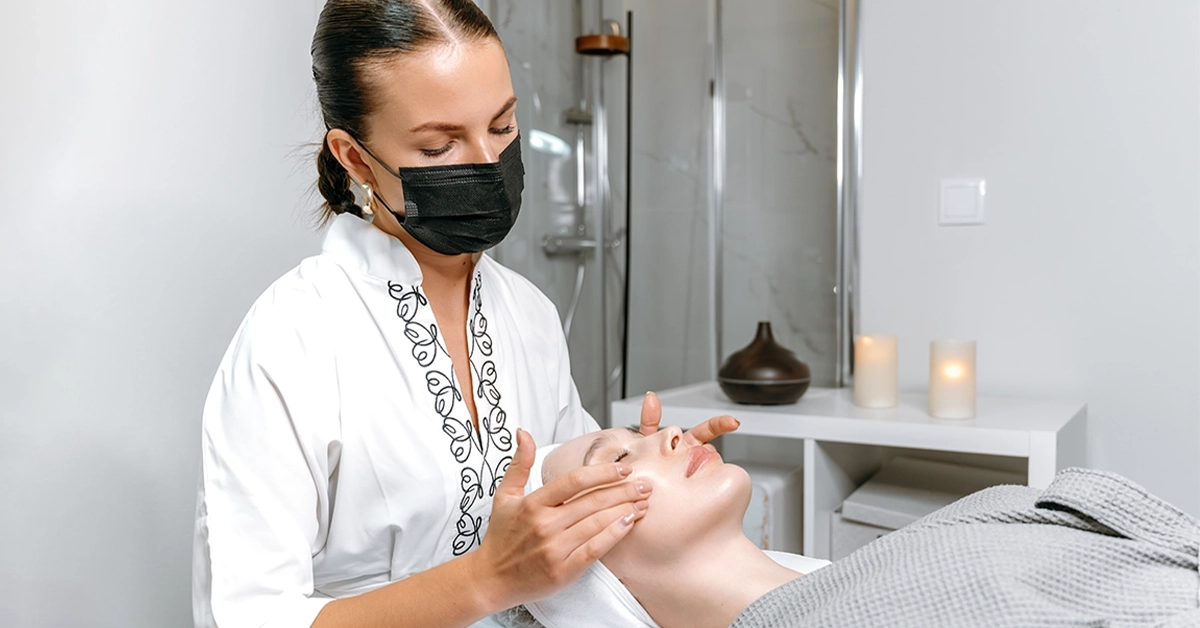 An expert providing face treatment to a client at Inside Jumeirah Beauty Salon