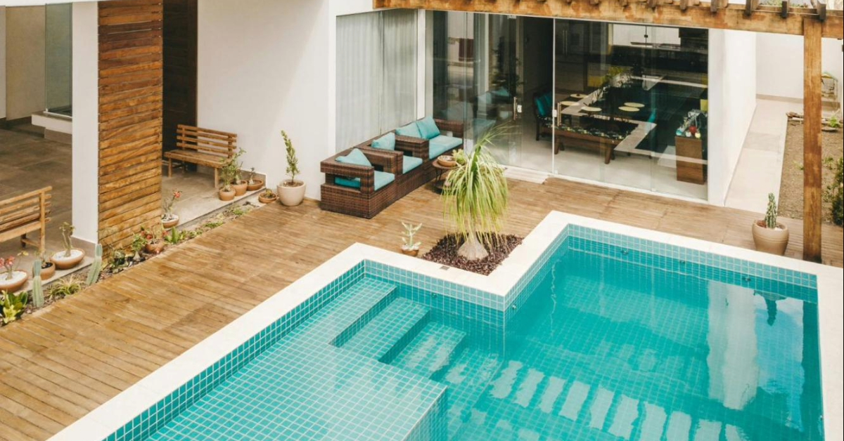 A pool with steps in a house’s backyard