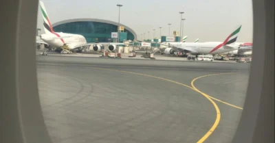 Airplane window showing airplanes on the ground