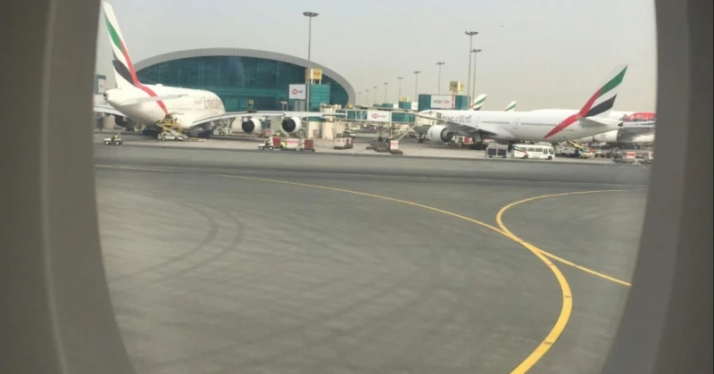 Airplane window showing airplanes on the ground