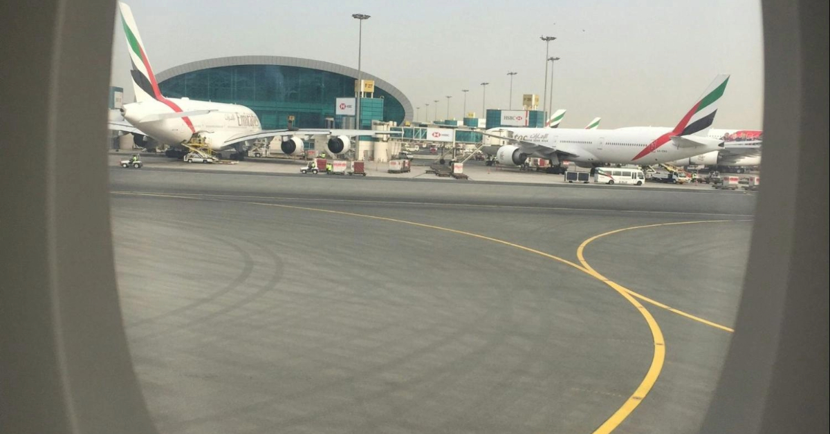 Airplane window showing airplanes on the ground