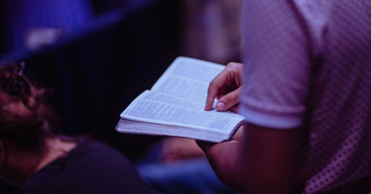 man reading bible in mass