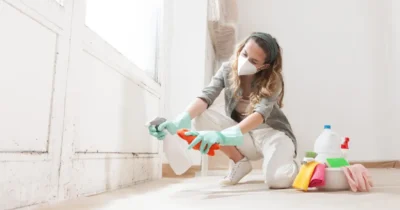 Woman cleaning the edges of a dirty wall