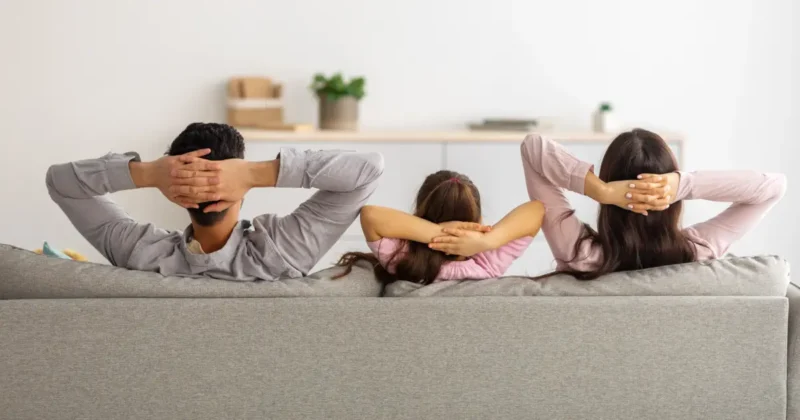 family relaxes on the couch after post-renovation cleaning