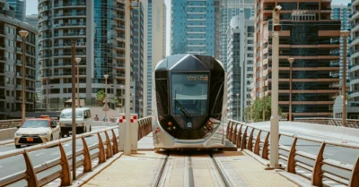 A Tram in the Middle of the Road Near Buildings in Dubai