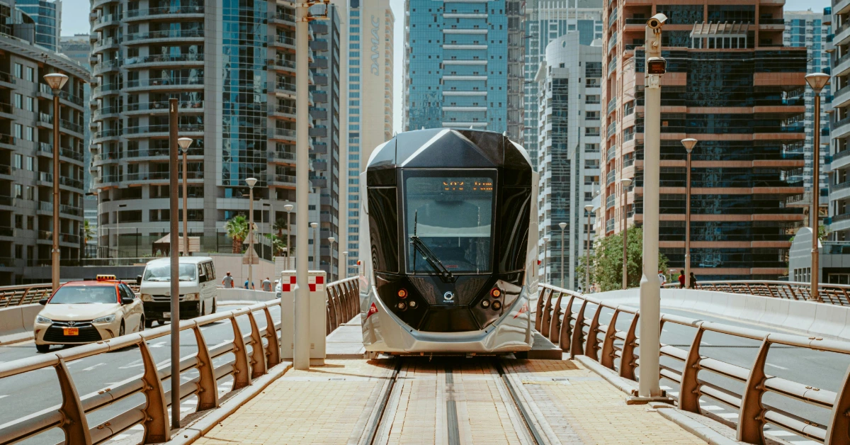 A Tram in the Middle of the Road Near Buildings in Dubai