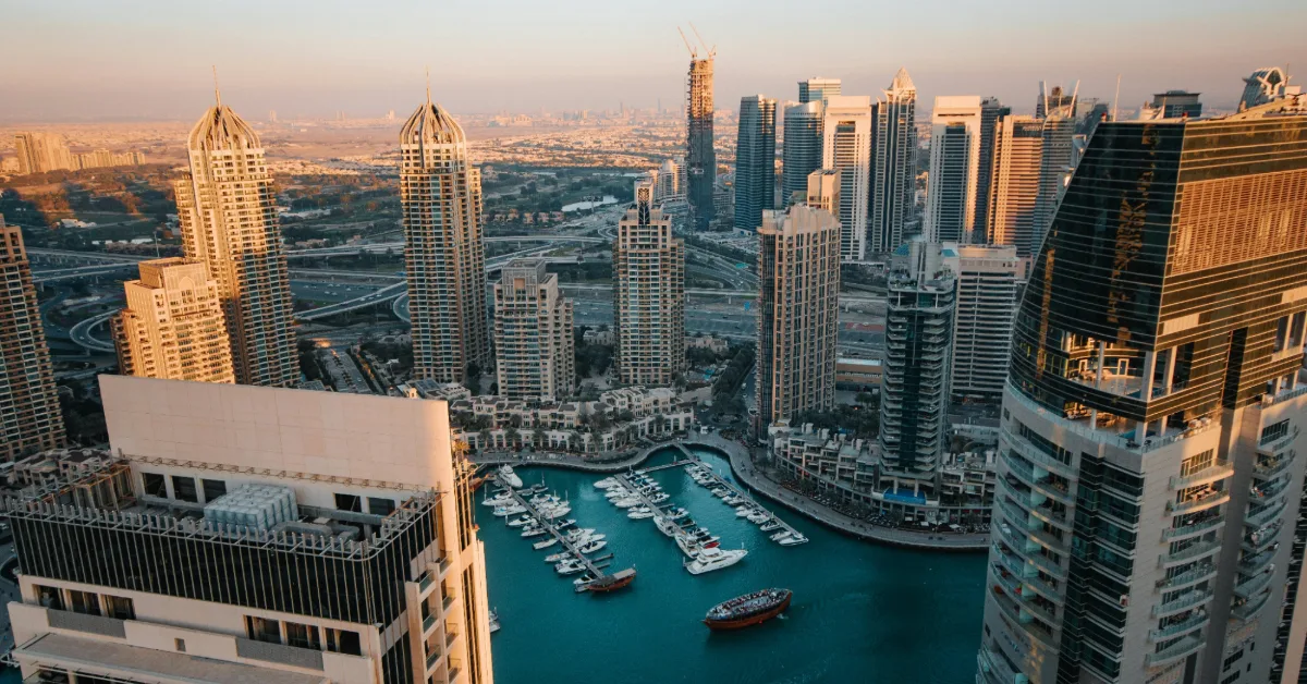Dubai Marina harbour with modern yachts near waterfront aerial timelapse.
