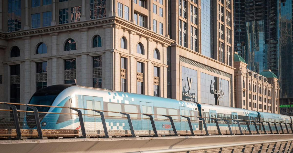 Dubai metro traveling beside modern buildings in Dubai Internet City