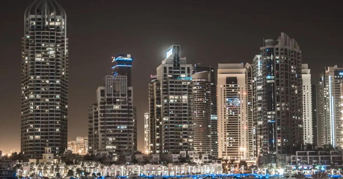 Illuminated Skyscrapers Near a Lake with Watercrafts in Dubai