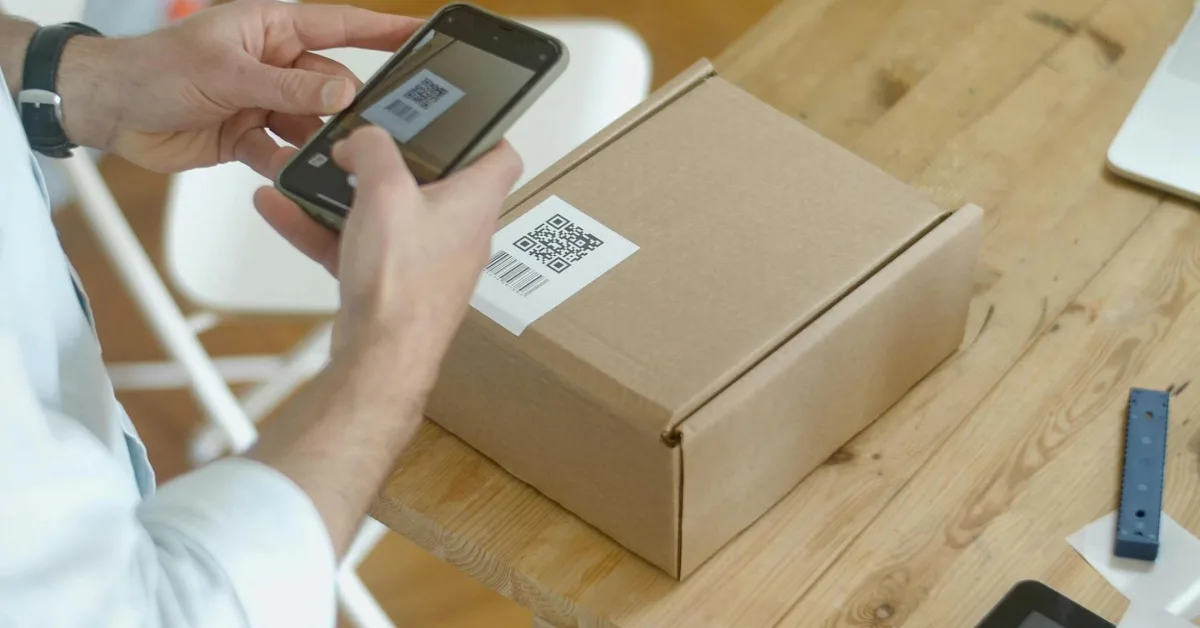 Person scanning the QR code on the box