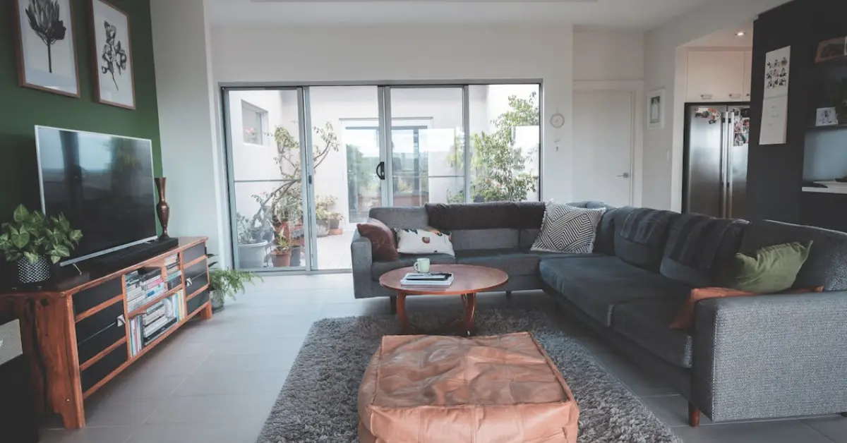 Spacious living room interior with cozy couch and pouf