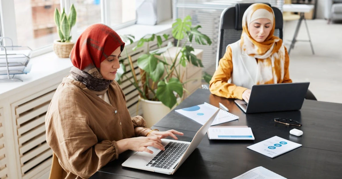 Women Typing on Their Laptop