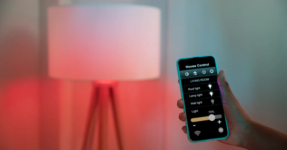 Hand holding smartphone with smart home lighting control app