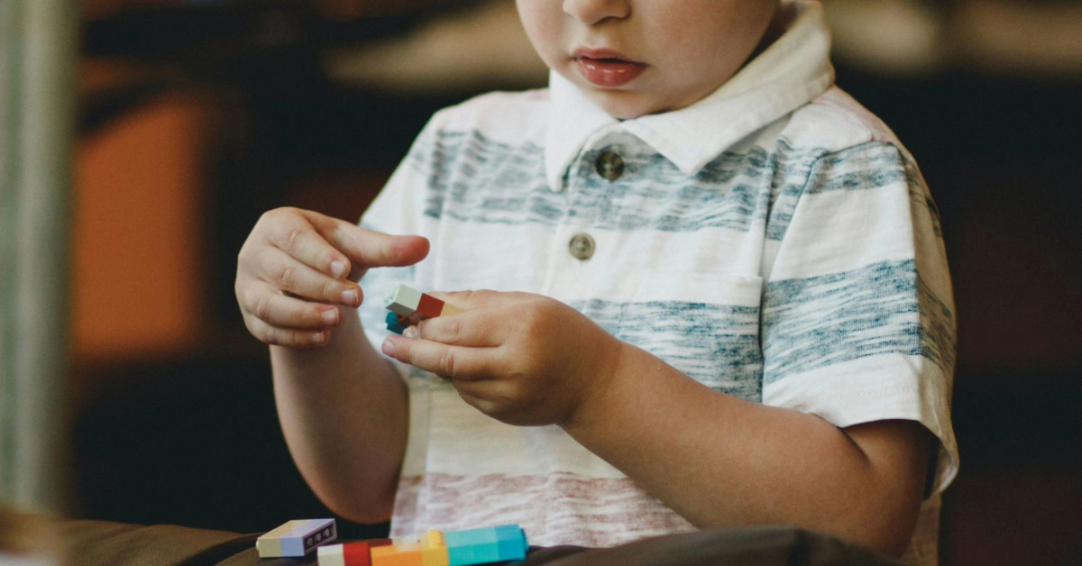 A kid putting together Legos