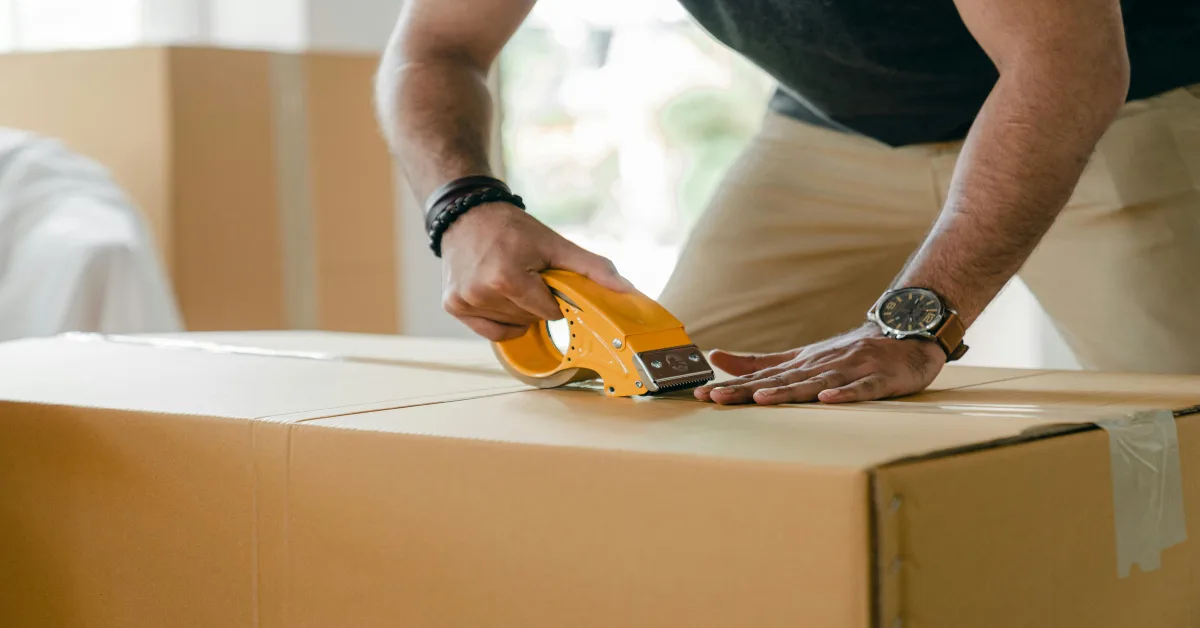 man preparing a box for shipping
