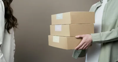 A Person Holding brown Boxes