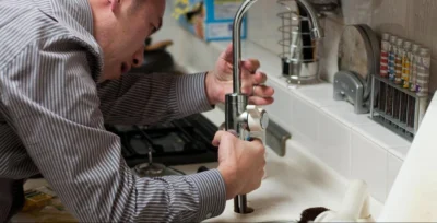 plumber working on bathroom to show where does bathroom renovations costs in dubai go