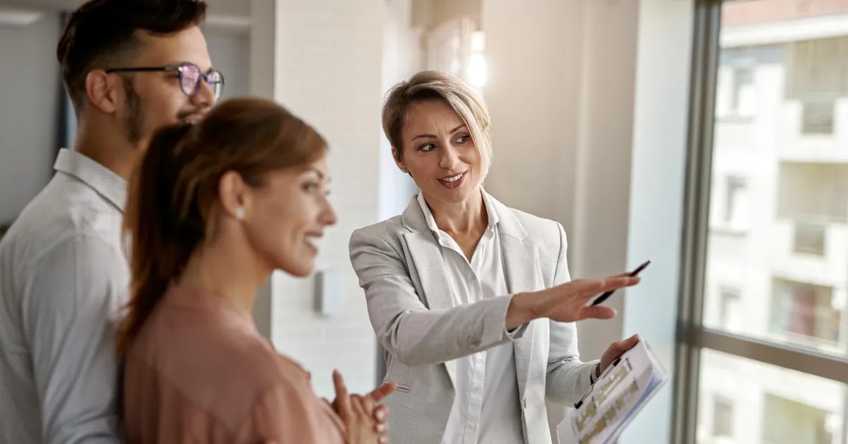 real estate broker talking with a couple interested in buying a new house