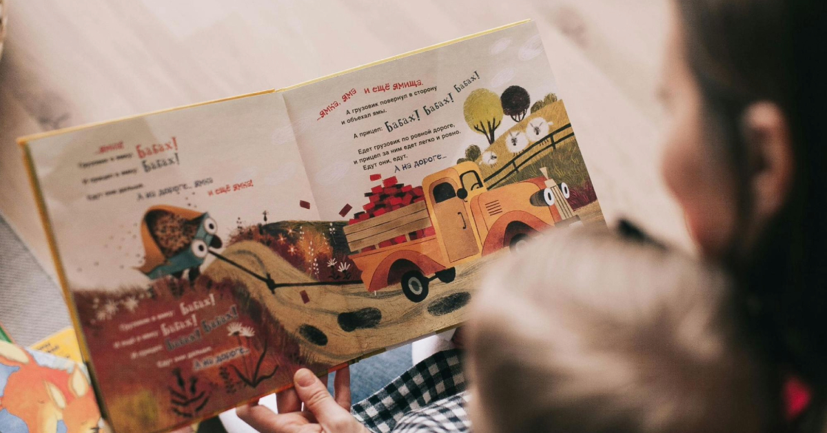 woman reading a storybook to a child