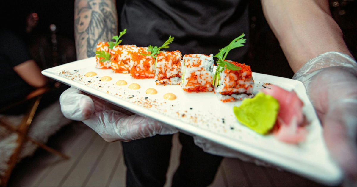 Waiter carrying sushi in a restaurant in Dubai