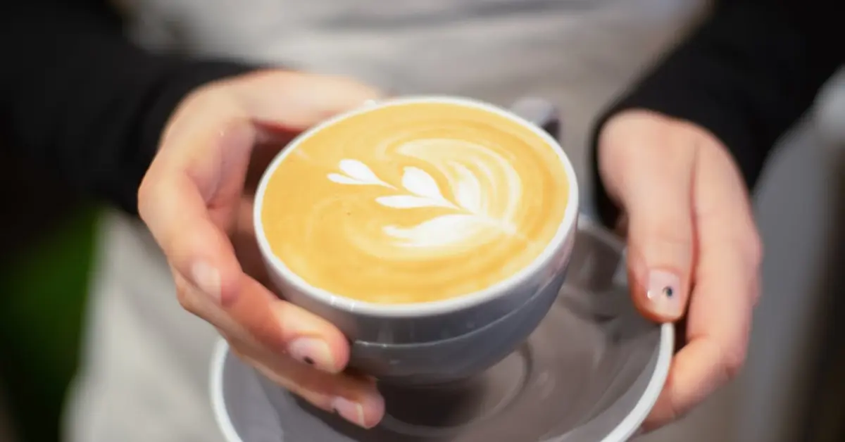 A Person Holding a Cup of Coffee