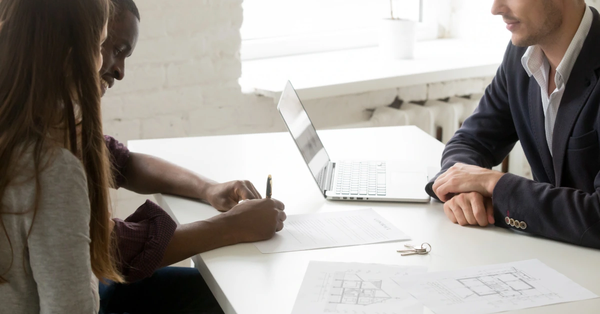 A couple signing their real estate agreement contract