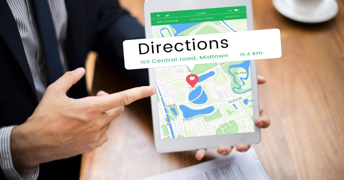 A man pointing at a GPS screen displaying direction to a location