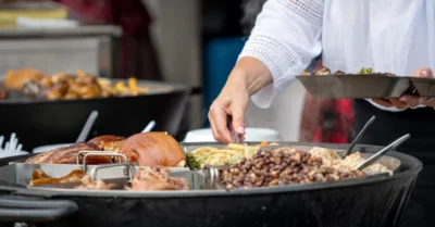 A woman serving herself in a food market