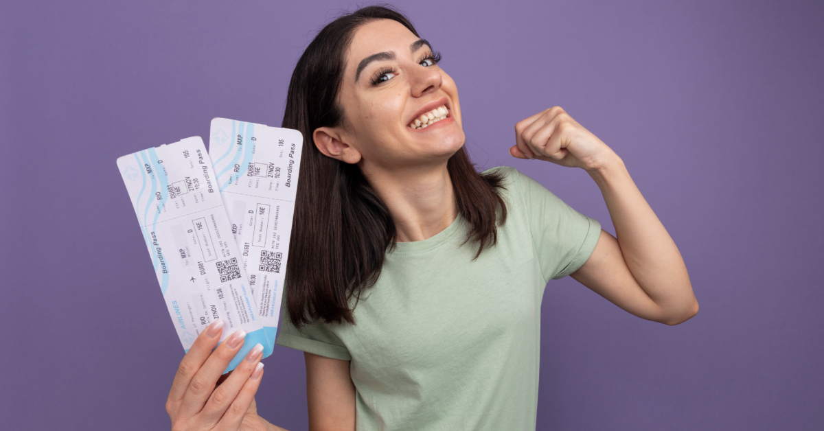 Happy girl with tickets for a Sheikh Rashid Auditorium event