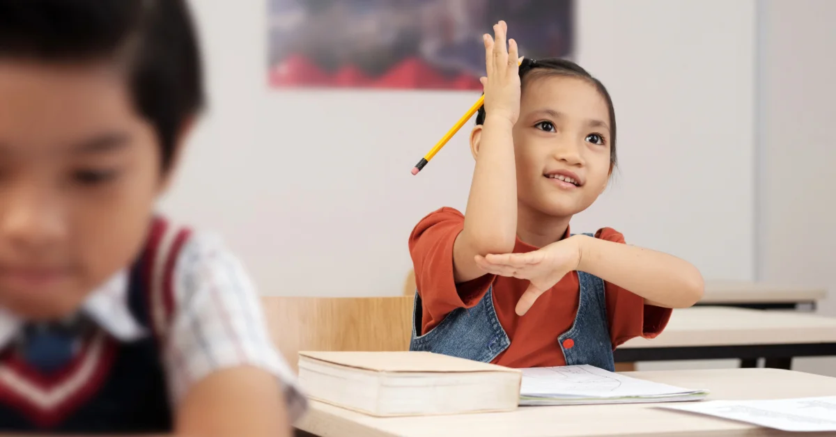 schoolgirl sitting at desk in classroom 