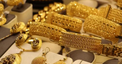 Gold bangles, chains, and earrings displayed in a store.