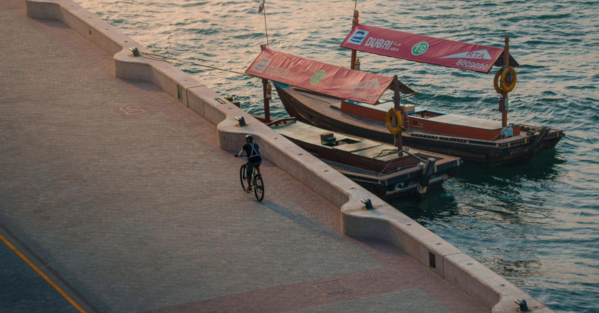 Cyclist on Dubai Waterfront at sunrise