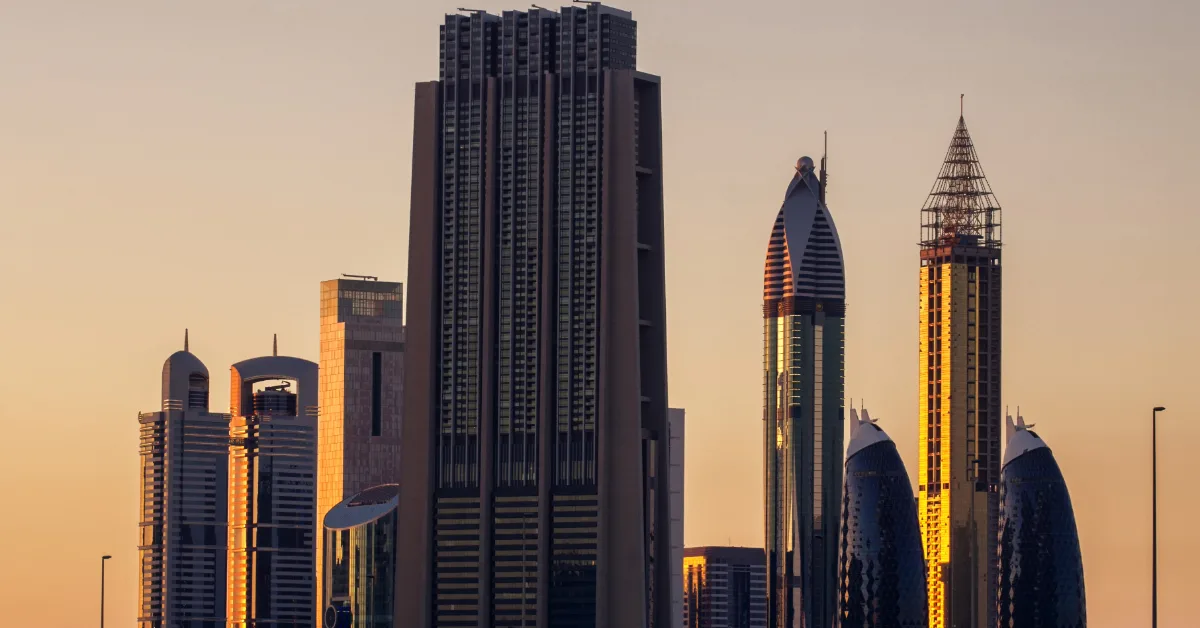 Dubai skyline at sunset with modern office towers and high-rise buildings.