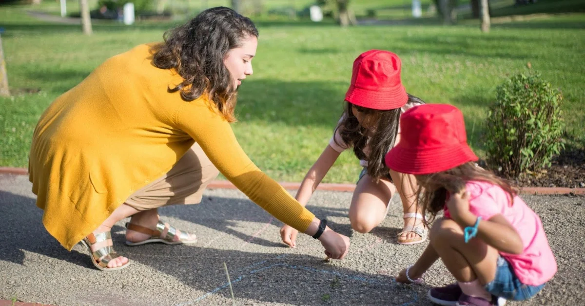 Nanny enjoying outdoor drawing with kids