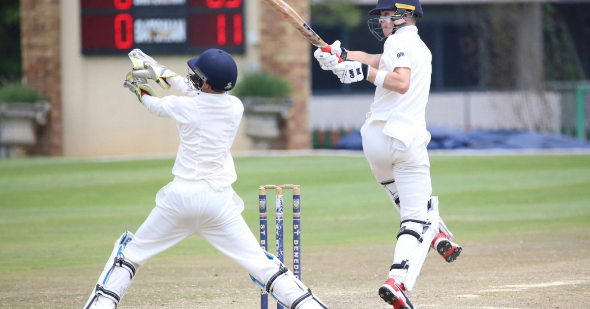 Two boys playing cricket in full gear