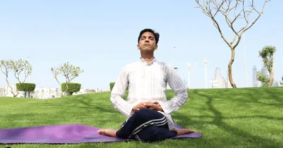 Man Sitting on Yoga Mat While Meditating at the park